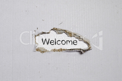 The word welcome appearing behind torn paper.