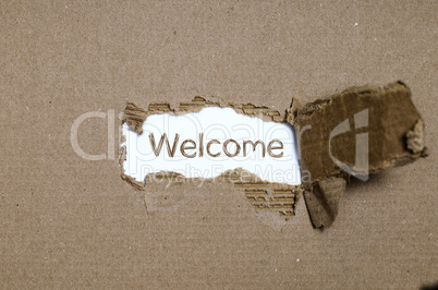 The word welcome appearing behind torn paper.