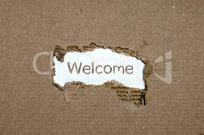 The word welcome appearing behind torn paper.