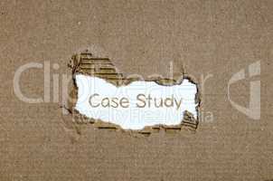 The word case study appearing behind torn paper.