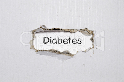 The word diabetes appearing behind torn paper.