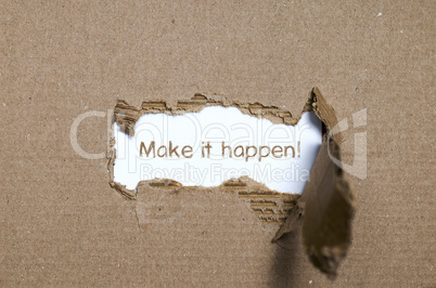 The word make it happen appearing behind torn paper.