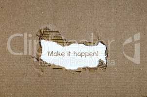 The word make it happen appearing behind torn paper.