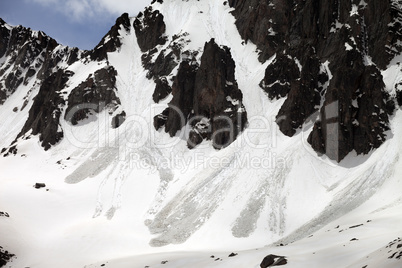 Snowy rocks with traces from avalanche