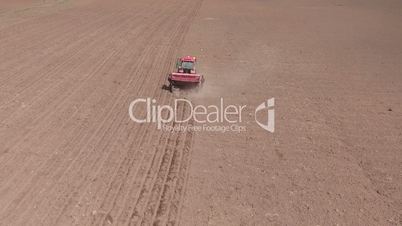 Aerial of tractor on harvest field