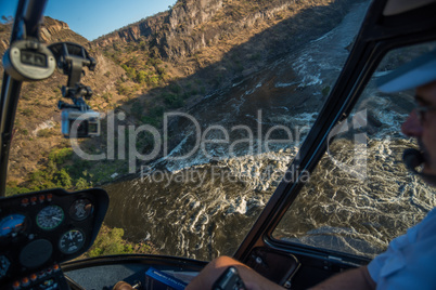 Aerial view of rapids from helicopter cockpit