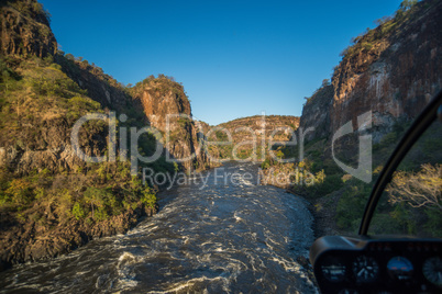 Aerial view of sunlit canyon with rapids