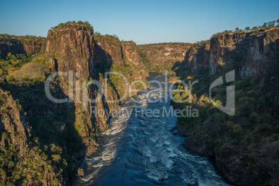 Aerial view of sunlit rapids from helicopter