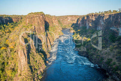 Aerial view of sunlit rapids in canyon