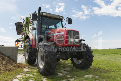 red tractor with tedder