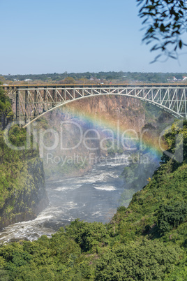 Rainbow crossing gorge beneath Victoria Falls Bridge