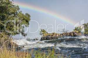 Rainbow seen from island in Victoria Falls
