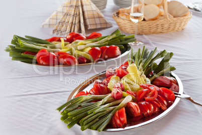 Sliced vegetables served on a silver tray