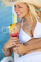 Beautiful Young Woman In Bikini Drinking Cocktail By The Sea
