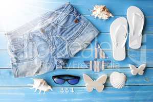 Sunny Summer Clothes And Decoration On Wooden Background