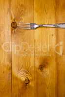 Fork on wooden background