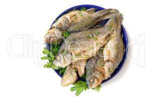 Roasted carp on a plate on a white background.