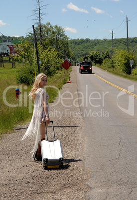 Young woman walking along street.