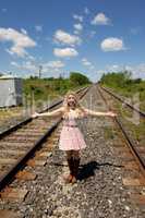 Young woman standing on railroad truck's.