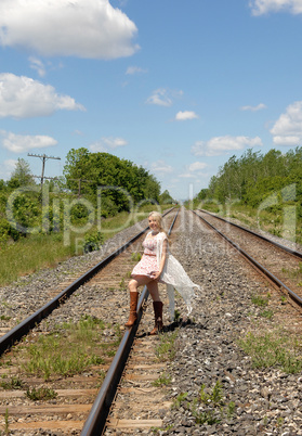 Pretty woman walking on railroad truck's.