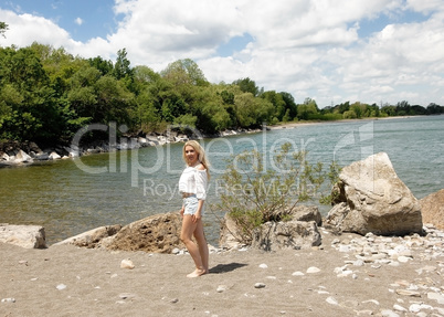 Gorgeous woman standing on beach.