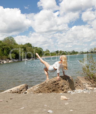 Young woman exercising on lake.