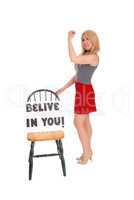Beautiful woman with sign "believe in you".
