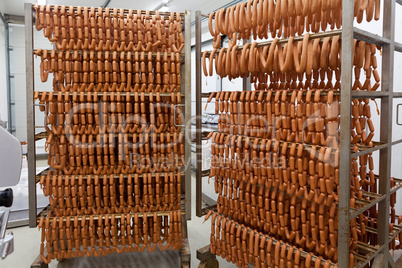 Homemade sausages on metal holders