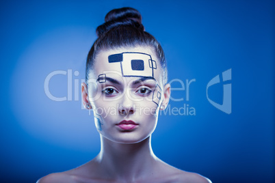 Closeup portrait of a lovely girl with creative makeup over blue background