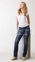 Alluring model posing in classic blouse and jeans