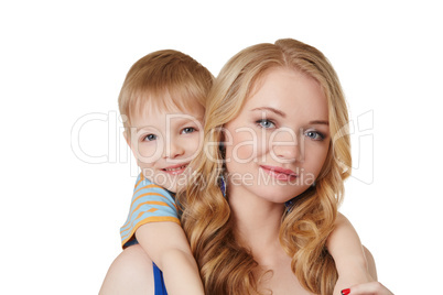 Portrait of pretty mother and son posing at camera