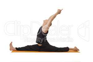 Yoga lessons. Middle aged man exercising in studio