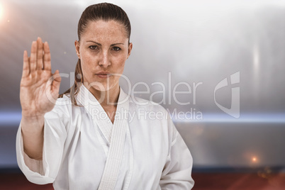 Composite image of female fighter performing karate stance