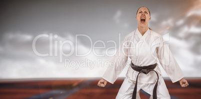 Composite image of female fighter posing after victory