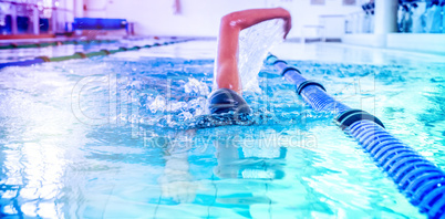 Fit swimmer doing the front stroke in the swimming pool