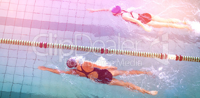 Female swimmers racing in the swimming pool