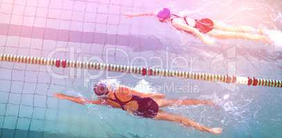 Female swimmers racing in the swimming pool