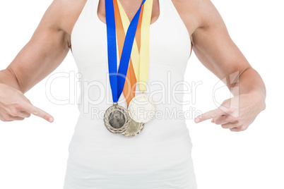 Female athlete pointing her medals