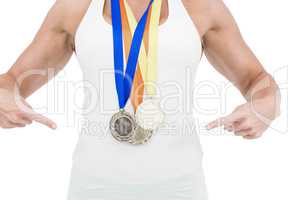 Female athlete pointing her medals