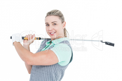 Pretty blonde posing with golf equipment