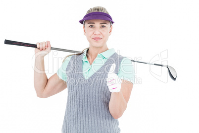 Pretty blonde playing golf and showing a thumbs up