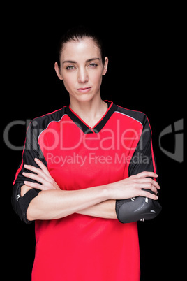 Female athlete posing with elbow pad and crossed arms