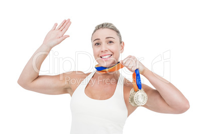 Happy female athlete holding medals Happy female athlete holding medals