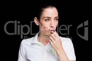 Female athlete blowing a whistle