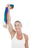Happy female athlete holding medals