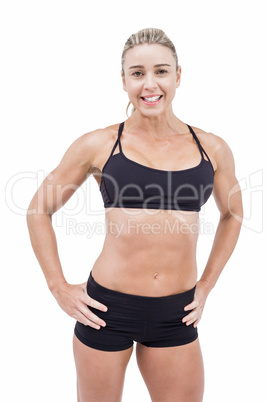 Female athlete posing with hands on hip