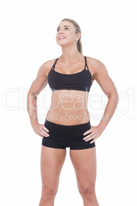 Female athlete posing with hands on hip