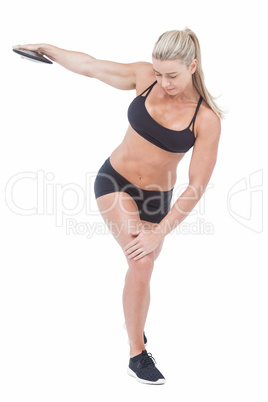 Female athlete throwing discus