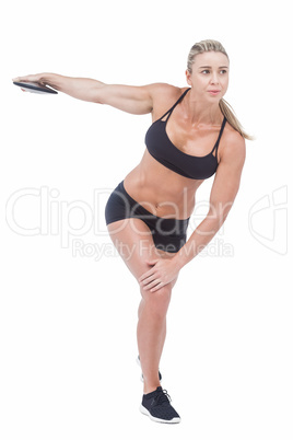 Female athlete throwing discus