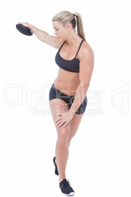 Female athlete throwing discus